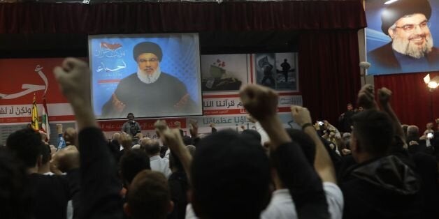 A picture taken on November 10, 2017, shows Hassan Nasrallah, the head of Lebanon's militant Shiite movement Hezbollah, giving a televised address during a gathering in Beirut's southern suburb.Nasrallah said Saad Hariri, who resigned as Lebanese prime minister from Riyadh last week, was 'detained' by Saudi Arabia. / AFP PHOTO / ANWAR AMRO (Photo credit should read ANWAR AMRO/AFP/Getty Images)