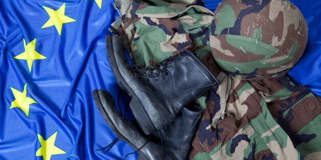 Military uniform and boots on European Union flag.