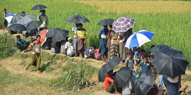 Rohingya refugees wait for relief aid at Balukhali refugee camp in the Bangladeshi district of Ukhia on October 24, 2017.Nations have pledged $340 million (290 million euros) to care for Myanmar's Rohingya refugees in Bangladesh, an 'encouraging' step in the response to the intensifying crisis, the UN said on October 23. / AFP PHOTO / Tauseef MUSTAFA (Photo credit should read TAUSEEF MUSTAFA/AFP/Getty Images)