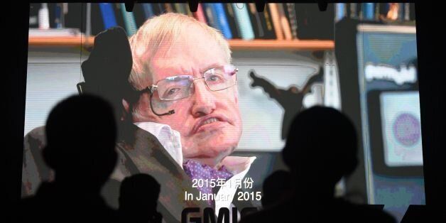Participants listen to a recorded speech by British physicist Stephen Hawking on artificial intelligence as his image is seen on a screen at the Global Mobile Internet Conference (GMIC) in Beijing on April 27, 2017. / AFP PHOTO / Greg Baker (Photo credit should read GREG BAKER/AFP/Getty Images)