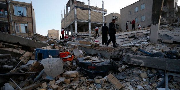People including rescue personnel conduct search and rescue work following a 7.3-magnitude earthquake at Sarpol-e Zahab in Iran's Kermanshah province on November 13, 2017.At least 164 people were killed and 1,600 more injured when a 7.3-magnitude earthquake shook the mountainous Iran-Iraq border triggering landslides that were hindering rescue efforts, officials said. / AFP PHOTO / ISNA / POURIA PAKIZEH (Photo credit should read POURIA PAKIZEH/AFP/Getty Images)