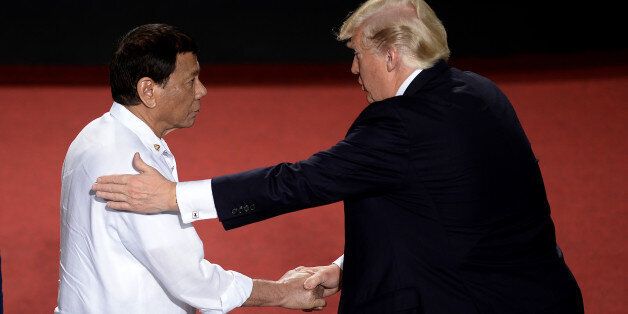 TOPSHOT - Philippine President Rodrigo Duterte shakes hands with US President Donald Trump (R) during the 31st Association of Southeast Asian Nations (ASEAN) Summit in Cultural Center of the Philippines (CCP) in Manila on November 13, 2017.World leaders are in the Philippines' capital for two days of summits. / AFP PHOTO / AFP PHOTO AND POOL / NOEL CELIS (Photo credit should read NOEL CELIS/AFP/Getty Images)