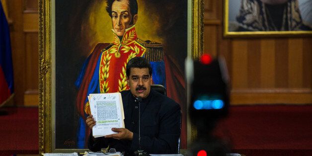 Nicolas Maduro, Venezuela's president, holds the agreement with the opposition for the nation wide gubernatorial election during a press conference at the Miraflores Palace in Caracas, Venezuela, on Tuesday, Oct. 17, 2017. In his speech, Maduro addressed Trump directly and claimed 'I am not a dictator,' then pleaded with oil and gold investors to bring money into the country. Photographer: Wil Riera/Bloomberg via Getty Images