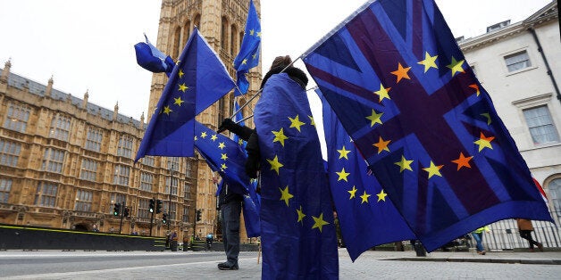 Anti-Brexit protesters wave EU and Union flags outside the Houses of Parliament in London, Britain, November 14, 2017. REUTERS/Peter Nicholls