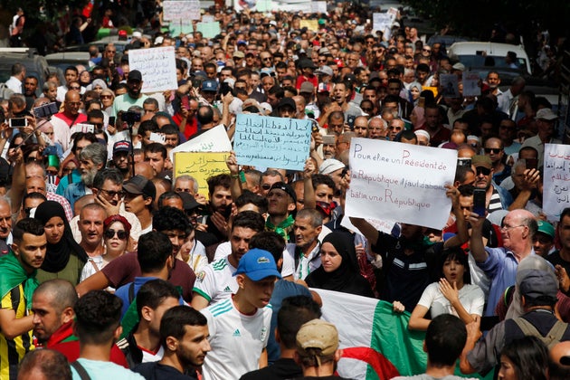 Algerian protesters carrying national flags chanted slogans during the student demonstration in Algiers,...