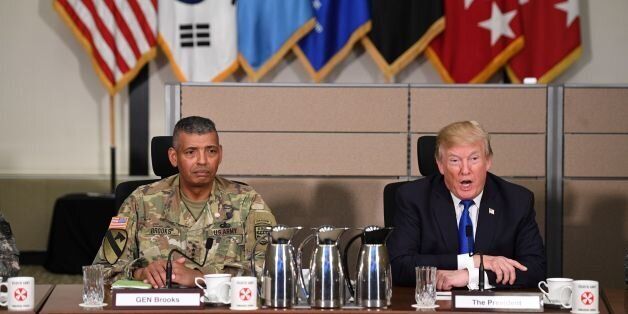 US President Donald Trump sits with US Forces Korea Commander General Vincent Brooks as he meets generals at the 8th Army Operational Command Centre at Camp Humphreys in Pyeongtaek, south of Seoul on November 7, 2017.Trump's marathon Asia tour moves to South Korea, another key ally in the struggle with nuclear-armed North Korea, but one with deep reservations about the US president's strategy for dealing with the crisis. / AFP PHOTO / JIM WATSON / The erroneous mention[s] appearing in the metadata of this photo by JIM WATSON has been modified in AFP systems in the following manner: [November] instead of [September]. Please immediately remove the erroneous mention[s] from all your online services and delete it (them) from your servers. If you have been authorized by AFP to distribute it (them) to third parties, please ensure that the same actions are carried out by them. Failure to promptly comply with these instructions will entail liability on your part for any continued or post notification usage. Therefore we thank you very much for all your attention and prompt action. We are sorry for the inconvenience this notification may cause and remain at your disposal for any further information you may require. (Photo credit should read JIM WATSON/AFP/Getty Images)