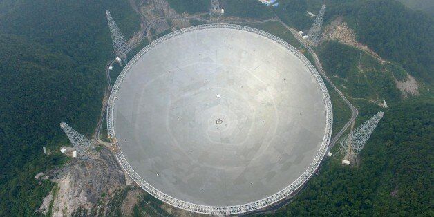 QIANNAN, CHINA - SEPTEMBER 17: Aerial view of a dish-like radio telescope at Pingtang County on September 17, 2016 in Qiannan Buyei and Miao Autonomous Prefecture, Guizhou Province of China. After five years' construction, 'Five hundred meter Aperture Spherical Telescope' (FAST) will be put into use on September 25. The local public security bureau has intensified security since September 16 in the core zone and around the radio telescope to ensure the radio telescope's completion goes well. (Photo by VCG/VCG via Getty Images)