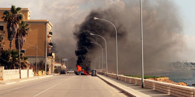 Burning car in the street of sicilian town.