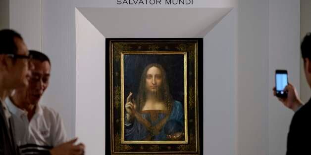 Visitors take photos after Leonardo da Vinci's 'Salvator Mundi' painting was unveiled in Hong Kong on October 13, 2017. / AFP PHOTO / Anthony WALLACE / RESTRICTED TO EDITORIAL USE - MANDATORY MENTION OF THE ARTIST UPON PUBLICATION - TO ILLUSTRATE THE EVENT AS SPECIFIED IN THE CAPTION (Photo credit should read ANTHONY WALLACE/AFP/Getty Images)