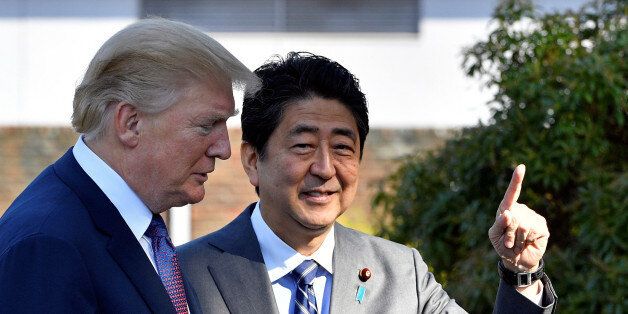 U.S. President Donald Trump (L) is welcomed by Japan's Prime Minister Shinzo Abe upon his arrival at the Kasumigaseki Country Club in Kawagoe, near Tokyo, Japan, November 5, 2017. REUTERS/Frank Robichon/Pool
