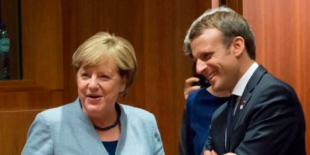 German Chancellor Angela Merkel (L), Britain's Prime minister Theresa May (unseen) and French President Emmanuel Macron talk as they arrive in Brussels, on October 19, 2017 during the summit of European Union (EU) leaders, set to rule out moving to full Brexit trade talks after negotiations stalled. / AFP PHOTO / JOHN THYS (Photo credit should read JOHN THYS/AFP/Getty Images)