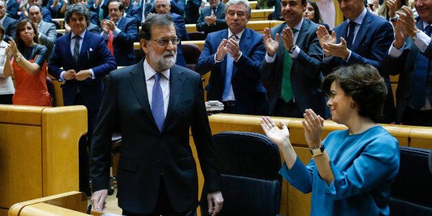 Spain's Prime Minister Mariano Rajoy (L) acknowledges applause during a session of the Upper House of Parliament in Madrid on October 27, 2017.The central government has invoked the never-before-used article 155 of the Constitution, designed to rein in rebel regions, as it seeks to end Catalonia's drive to break from Spain. Spain's upper house is in charge of approving or rejecting the power seizure of the semi-autonomous Catalonia region proposed by Madrid. / AFP PHOTO / OSCAR DEL POZO (Photo credit should read OSCAR DEL POZO/AFP/Getty Images)