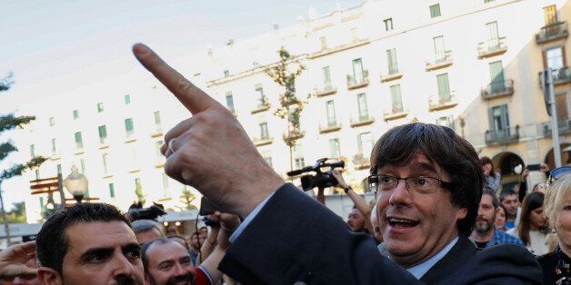 Sacked Catalan President Carles Puigdemont gestures after leaving a restaurant the day after the Catalan regional parliament declared independence from Spain in Girona, Spain, October 28, 2017. REUTERS/Rafael Marchante