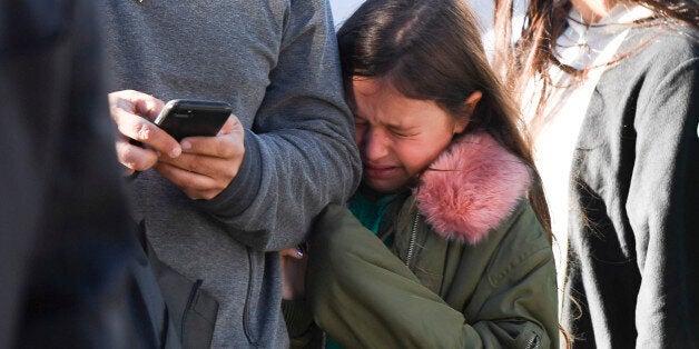 A young girl reacts as police officers secure an area following a shooting incident in New York on October 31, 2017. Several people were killed and numerous others injured in New York on Tuesday after a vehicle plowed into a pedestrian and bike path in Lower Manhattan, police said. 'The vehicle struck multiple people on the path,' police tweeted. 'The vehicle continued south striking another vehicle. The suspect exited the vehicle displaying imitation firearms & was shot by NYPD.' / AFP PHOTO / Don EMMERT (Photo credit should read DON EMMERT/AFP/Getty Images)