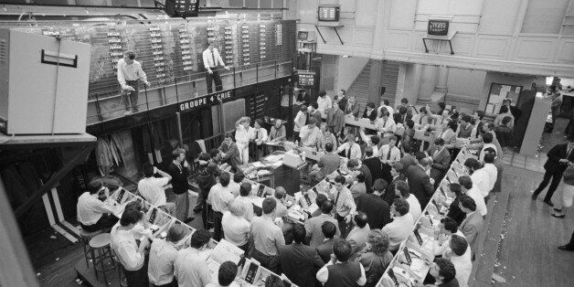 Traders keep an eye on the latest figures at the end of a difficult week at the Paris Stock Exchange. October 19, 1987, dubbed Black Monday, heralded the largest market crash since Black Tuesday in 1929. Stock trading markets worldwide suffered major devaluations after a drop starting the preceding Thursday, October 15, and prices continued to fluctuate wildly throughout the following week. (Photo by Bernard Bisson/Sygma via Getty Images)