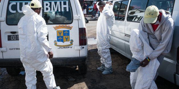 Council workers get ready to start the clean-up operation of the market of Anosibe in the Anosibe district, one of the most unsalubrious district of Antananarivo on October 10, 2017.The World Health Organization has warned that a deadly outbreak of the plague, which began in late August, has claimed more than 20 lives in Madagascar and is swiftly spreading in cities across the country. Rats are porters of fleas which spread the bubonic plague and are attracted by garbages and unsalubrity. Pneumonic plague, which is passed through person-to-person transmission, has also been recorded. / AFP PHOTO / RIJASOLO (Photo credit should read RIJASOLO/AFP/Getty Images)