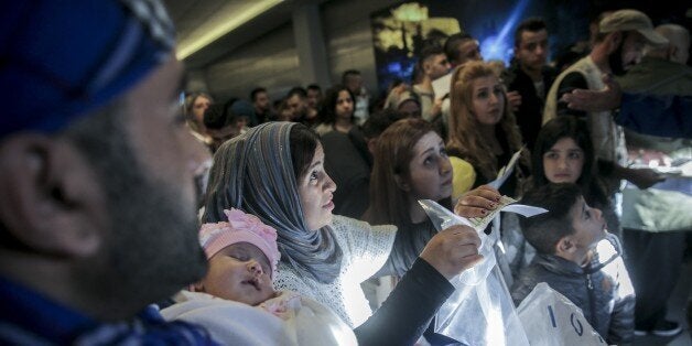 ATHENS, GREECE - OCTOBER 18: People wait at Athens International Airport as 234 refugees are transferred to Lyon of France within the EU Relocation Programme of International Organization for Migration (IOM) in Athens, Greece on October 18, 2017. (Photo by Ayhan Mehmet/Anadolu Agency/Getty Images)