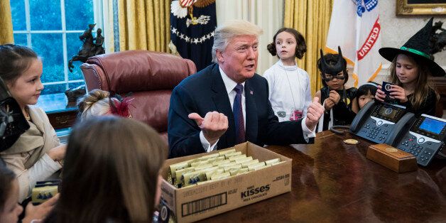 WASHINGTON, DC - OCTOBER 27: President Donald Trump meets with and hands out candy to children of journalists and White House staffers for Halloween in the Oval Office of the White House in Washington, DC on Friday, Oct. 27, 2017. (Photo by Jabin Botsford/The Washington Post via Getty Images)