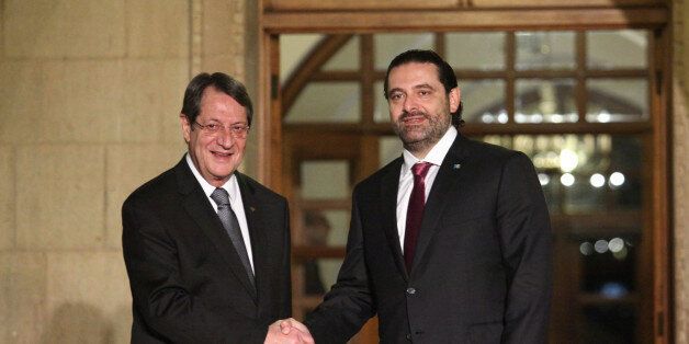Cypriot President Nicos Anastasiades (L) and Lebanon's Prime Minister Saad al-Hariri shake hands outside the Presidential Palace in Nicosia, Cyprus October 28, 2017. REUTERS/Yiannis Kourtoglou