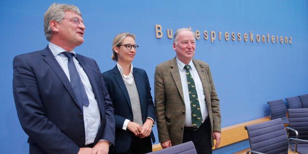 Joerg Meuthen (L), leader of the anti-immigration party Alternative fuer Deutschland (AfD) poses next to top candidates Alice Weidel and Alexander Gauland (R) at the end of a news conference in Berlin, Germany, September 25, 2017. REUTERS/Wolfgang Rattay