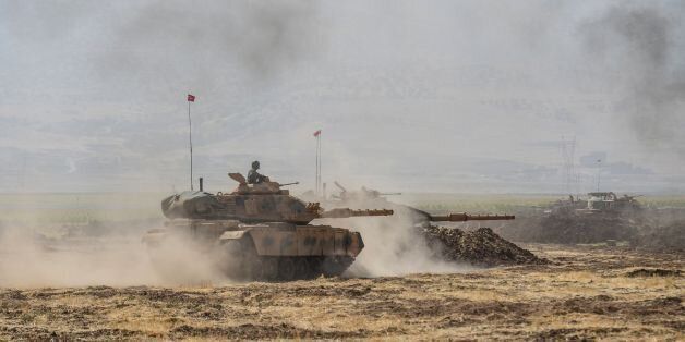 Turkish soldier ride tanks during military exercises near the Habur crossing gate between Turkey and Iraq on September 27, 2017 in the Silopi district, southeast Turkey. Iraqi soldiers on September 26 took part in a Turkish military drill close to the Iraqi border on Tuesday, an AFP photographer said, a day after Iraq's Kurdish region held a vote on independence. / AFP PHOTO / ILYAS AKENGIN (Photo credit should read ILYAS AKENGIN/AFP/Getty Images)