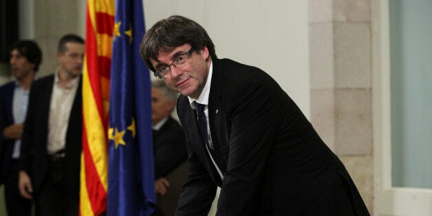 Catalan President Carles Puigdemont signs a declaration of independence at the Catalan regional parliament in Barcelona, Spain, October 10, 2017. REUTERS/Albert Gea