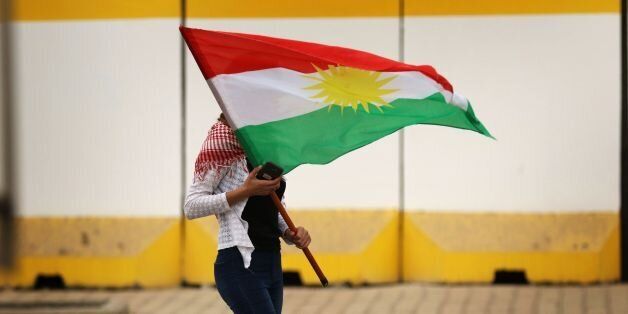 An Iraqi Kurd marches with a Kurdish flag during a protest in support of the Iraqi Kurdish leader, in Arbil, the capital of autonomous Iraqi Kurdistan, on October 30, 2017. Long-time Kurdish leader Massud Barzani, the architect of the referendum, announced on October 29, 2017 he is stepping down after it led to Iraq's recapture of almost all disputed territories that had been under Kurdish control. / AFP PHOTO / SAFIN HAMED (Photo credit should read SAFIN HAMED/AFP/Getty Images)