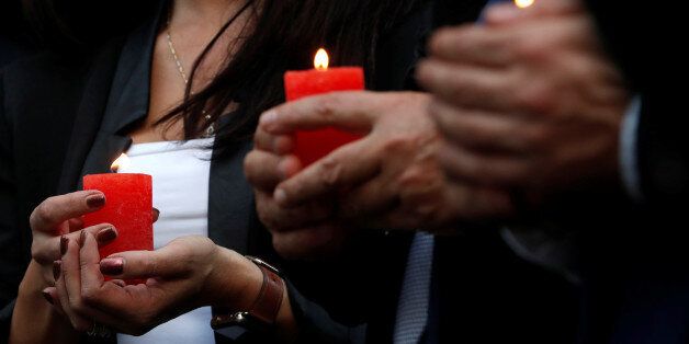 People hold candles as they gather for a candlelight vigil in memory of Malta's journalist Daphne Caruana Galizia in Brussels, Belgium, October 18, 2017. REUTERS/Yves Herman