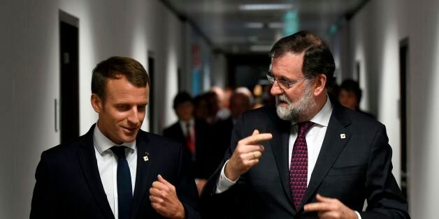 French President Emmanuel Macron (L) speaks with Spanish Prime Minister Mariano Rajoy (R) on their way to a meeting during the EU leaders summit in Brussels, on October 19, 2017. / AFP PHOTO / JOHN THYS (Photo credit should read JOHN THYS/AFP/Getty Images)