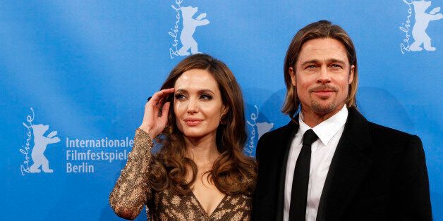 U.S. actress and director Angelina Jolie and her partner actor Brad Pitt arrive for the screening of the movie 'The Land Of Blood And Honey' at the 62nd Berlinale International Film Festival in Berlin February 11, 2012. REUTERS/Fabrizio Bensch (GERMANY - Tags: ENTERTAINMENT)