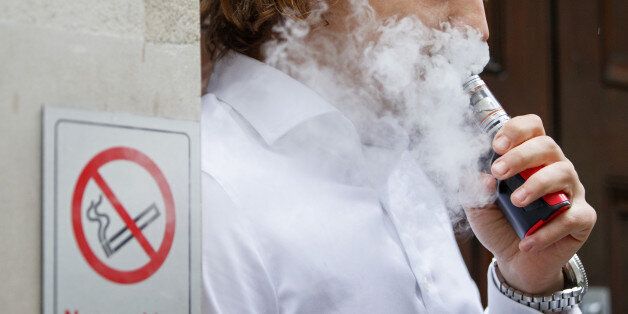 A smoker is engulfed by vapours as he smokes an electronic vaping machine during lunch time in central London on August 9, 2017.World stock markets and the dollar slid Wednesday after US President Donald Trump warned of 'fire and fury' in retaliation to North Korea's nuclear ambitions, sending traders fleeing to safe-haven investments. In Europe, equities dived with London losing 0.6 percent, while Frankfurt shed 1.1 percent and Paris fell 1.4 percent. / AFP PHOTO / Tolga Akmen (Photo credit should read TOLGA AKMEN/AFP/Getty Images)