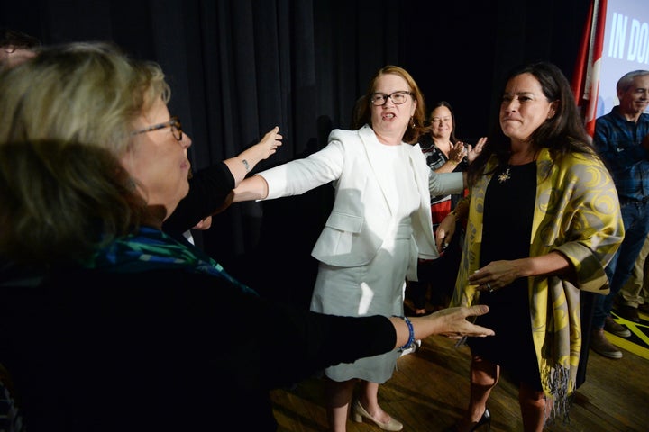 Independent candidates Jody Wilson-Raybould, right, and Jane Philpott, centre, and Green Party Leader Elizabeth May hug in Vancouver on Sept. 18, 2019.