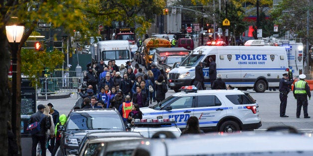 NEW YORK, NY - NOVEMBER 1: Morning commuters and pedestrians maneuver through the closed intersection at Murray Street and West Highway crossing over the closed bike path where Sayfullo Saipov, an Uzbek immigrant, drove a rental truck down for twenty blocks killing eight people and injuring several more on November 1, 2017 in New York, NY. (Photo by Ricky Carioti/The Washington Post via Getty Images)