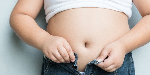 The size of stomach of fat boy with overweight.