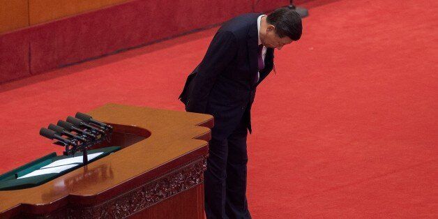 China's President Xi Jinping bows to delegates after delivering a speech at the opening session of the Chinese Communist Party's Congress at the Great Hall of the People in Beijing on October 18, 2017. President Xi Jinping declared China is entering a 'new era' of challenges and opportunities on October 18 as he opened a Communist Party congress expected to enhance his already formidable power. / AFP PHOTO / Nicolas ASFOURI (Photo credit should read NICOLAS ASFOURI/AFP/Getty Images)