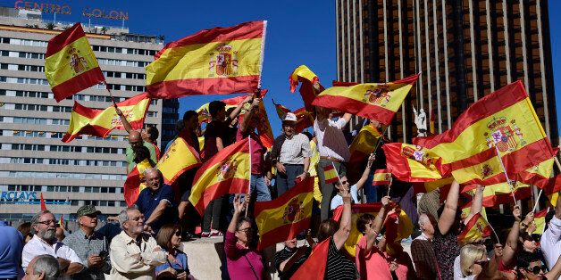 Protestors gather holding Spanish flags during a demonstration against independence of Catalonia called by DENAES foundation for the Spanish Nation Defence at Colon square in Madrid on October 07, 2017..Spain braced for more protests despite tentative signs that the sides may be seeking to defuse the crisis after Madrid offered a first apology to Catalans injured by police during their outlawed independence vote. / AFP PHOTO / JAVIER SORIANO (Photo credit should read JAVIER SORIANO/AFP/Getty Images)