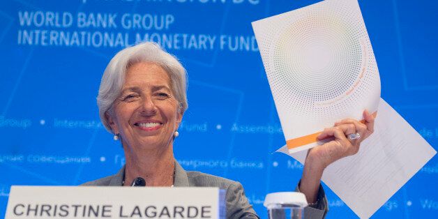 IMF Managing Director Christine Lagarde holds up the Global Policy Agenda during a press conference during the World Bank Group / International Monetary Fund Annual Meetings at IMF Headquarters in Washington, DC, October 12, 2017. / AFP PHOTO / SAUL LOEB (Photo credit should read SAUL LOEB/AFP/Getty Images)