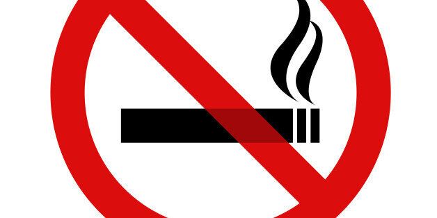 Black and red no smoking sign with shadow against a white background