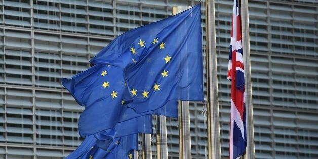 A Union Jack (R) hangs down next to European Union flags fluttering in front of the European Commission building as British Prime Minister May is due to meet European Commission President Juncker for a dinner in a bid to unblock Brexit talks ahead of a decisive EU summit this week, in Brussels on October 16, 2017.EU leaders meeting in Brussels on October 19 and 20 are due to decide whether or not negotiators can move on to discussing post-Brexit trade ties with Britain if 'sufficient progress' has been made in divorce talks. The indication from the EU side is that they will postpone their decision to a summit in December as the break-up negotiations are currently deadlocked, particularly over the multi-billion-euro exit bill the EU says Britain must pay. / AFP PHOTO / EMMANUEL DUNAND (Photo credit should read EMMANUEL DUNAND/AFP/Getty Images)