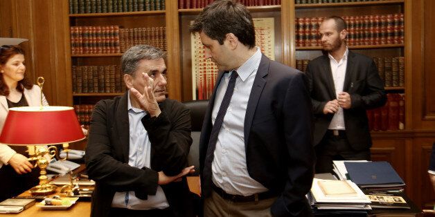 Greek Finanace Minister Euclid Tsakalotos (L) and George Chouliarakis, Alternate Finance Minister at Maximos mansion, in Athens on June 12, 2017 (Photo by Panayotis Tzamaros/NurPhoto via Getty Images)