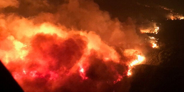 A wildfire is shown from the air near Atlas Road during an operation to rescue people trapped by wildfire in Napa, California, U.S., October 9, 2017. Photo taken October 9, 2017. Courtesy California Highway Patrol/Handout via REUTERS ATTENTION EDITORS - THIS IMAGE WAS PROVIDED BY A THIRD PARTY TPX IMAGES OF THE DAY