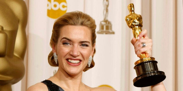 Best actress winner Kate Winslet of England poses with her Oscar for her role in