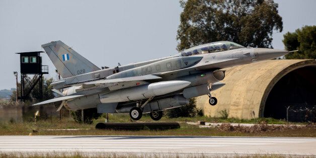 A Hellenic Air Force F-16D Block 52+ with a DB-110 reconnaissance pod, landing in front of the ex-nuclear QRA site at Araxos Air Base, Greece.