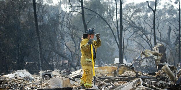 SANTA ROSA, CA - OCTOBER 13: A firefighter pauses for a moment while looking through the rubble of a home in the Fountaingrove neighborhood on October 13, 2017 in Santa Rosa, California. Twenty four people have died in wildfires that have burned tens of thousands of acres and destroyed over 3,500 homes and businesses in several Northern California counties. (Photo by Elijah Nouvelage/Getty Images)