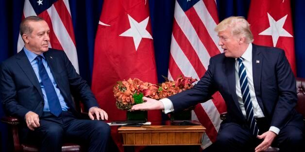 US President Donald Trump reaches to shake Turkey's President Recep Tayyip Erdogan's hand before a meeting at the Palace Hotel during the 72nd United Nations General Assembly on September 21, 2017 in New York City. / AFP PHOTO / Brendan Smialowski (Photo credit should read BRENDAN SMIALOWSKI/AFP/Getty Images)