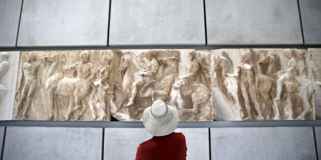 A man looks at exhibits at the Parthenon hall of the Acropolis museum in Athens May 18, 2015. Museums across Greece offered free admission to visitors on Monday to celebrate International Museum Day. REUTERS/Alkis Konstantinidis