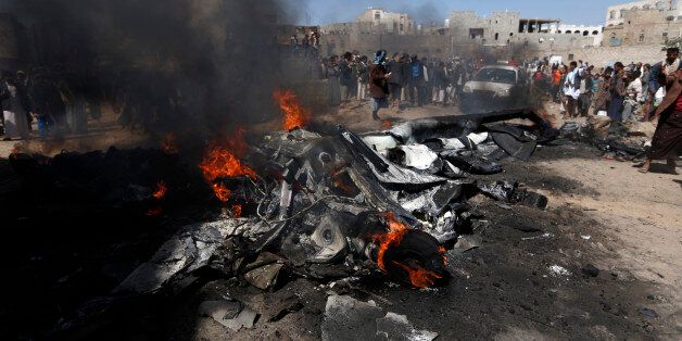 Yemenis gather around burning wreckage of a drone in the country's capital Sanaa, on October 1, 2017.A drone crashed at the northern exit of the Yemeni capital without causing casualties and the Houthis rebels claimed that it had been shot down by their anti-aircraft defense. / AFP PHOTO / MOHAMMED HUWAIS (Photo credit should read MOHAMMED HUWAIS/AFP/Getty Images)