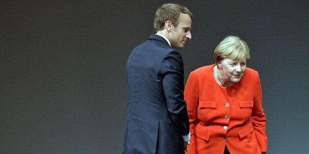 FRANKFURT AM MAIN, GERMANY - OCTOBER 10: German Chancellor Angela Merkel and the French President Emmanuel Macron react during the opening of the Frankfurt Book Fair 2017 (Frankfurter Buchmesse) on October 10, 2017 in Frankfurt, Germany. The two leaders are known to have a good working relationship and share a number of policy views. The Frankfurt Book Fair will be open to the public from October 11-15. (Photo by Thomas Lohnes/Getty Images)