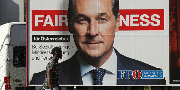 VIENNA, AUSTRIA - OCTOBER 14: A man of African origin walks past an election campaign billboard that shows Heinz-Christian Strache, lead candidate of the right-wing Austria Freedom Party (FPOe), on October 14, 2017 in Vienna, Austria. Austria faces parliamentary elections on October 15 and the FPOe, which is running on a 'fairness for Austrians' campaign with strong anti-immigrant, anti-refugee and anti-Islam tones, is currently in third place in polls and could well become a coalition partner in the next Austrian government. (Photo by Sean Gallup/Getty Images)