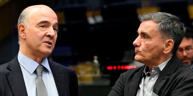 EU's Economic Affairs Commissioner, Pierre Moscovici (L) talks with Greece's Finance minister Euclid Tsakalotos during a Eurozone Finance ministers meeting in Luxembourg on October 9, 2017. / AFP PHOTO / JOHN THYS (Photo credit should read JOHN THYS/AFP/Getty Images)